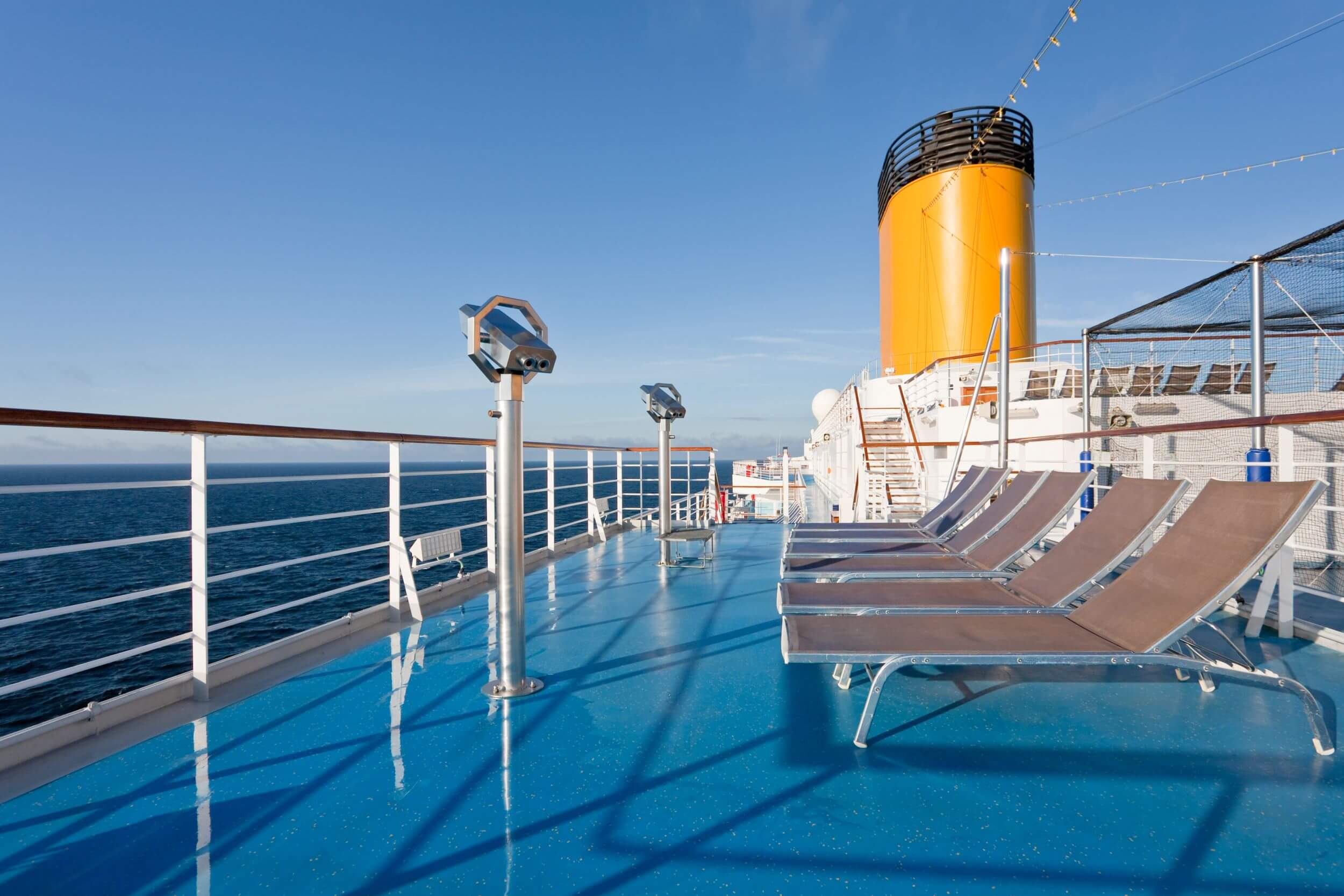 A set of chairs on a deck of a cruise ship
