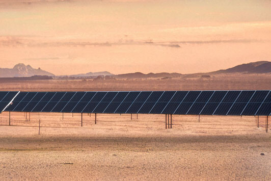 Utility-scale solar panels installed in a desert landscape